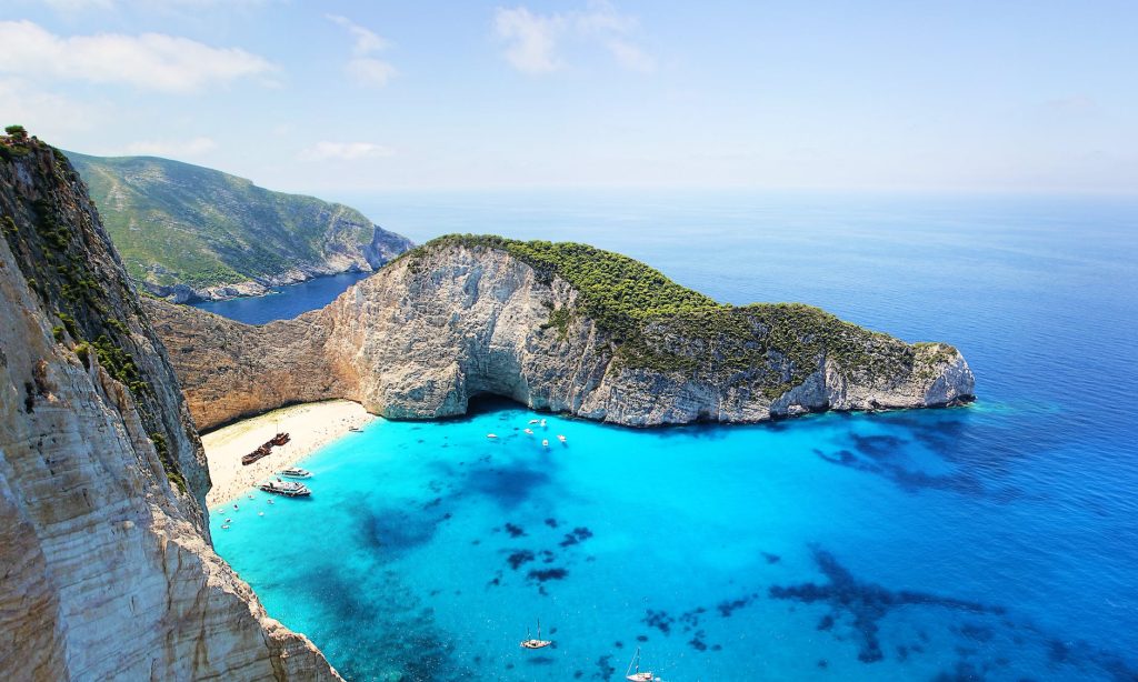 Greece Beaches, Crystal Waters, Golden Sand, Coastal Scenery, Volcanic Beauty, Hidden Gem, Secluded Paradise, Vibrant Hotspot, Serene Environment, Unique Pink Sand, Gorila Travel,